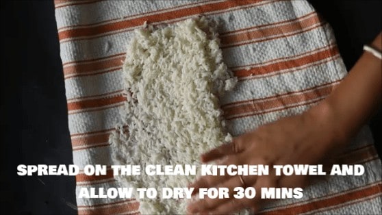Spreading rice on kitchen towel after draining to make sure no water is remaining.